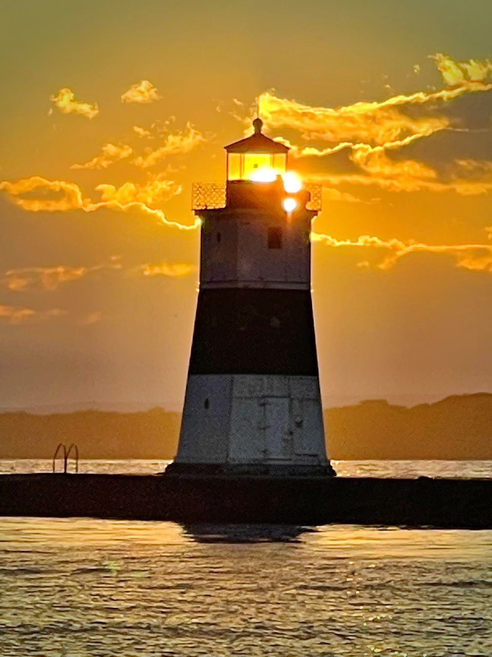 lighthouse, architecture, sunset, guidance, sky, water, sea, built structure, building exterior, tower, building, nature, cloud, security, ocean, protection, land, beach, travel destinations, environment, coast, dawn, beauty in nature, travel, evening, no people, scenics - nature, sunlight, silhouette, orange color, landscape, horizon, sun, outdoors, reflection, history, the past, coastline, back lit, nautical vessel, tranquility, illuminated, transportation