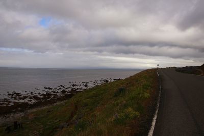 Road by sea against sky