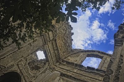 Low angle view of old ruins against sky