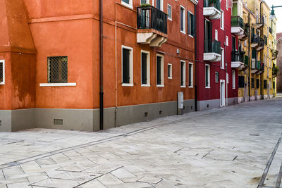 Footpath amidst buildings in city