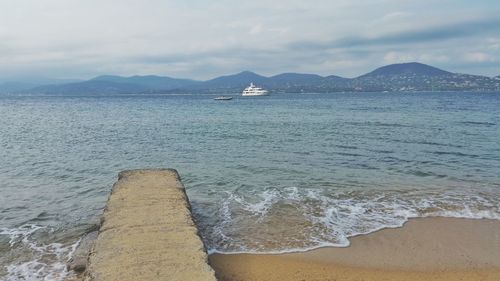 Scenic view of sea against cloudy sky