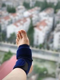 Low section of woman wearing bandage in city