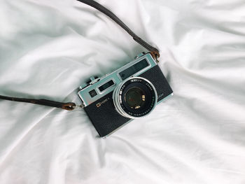 High angle view of eyeglasses on bed