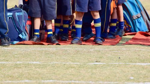 Low section of players standing on ground