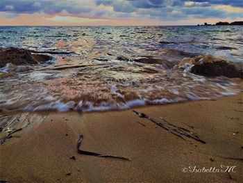 Scenic view of beach at sunset