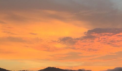 Low angle view of dramatic sky during sunset