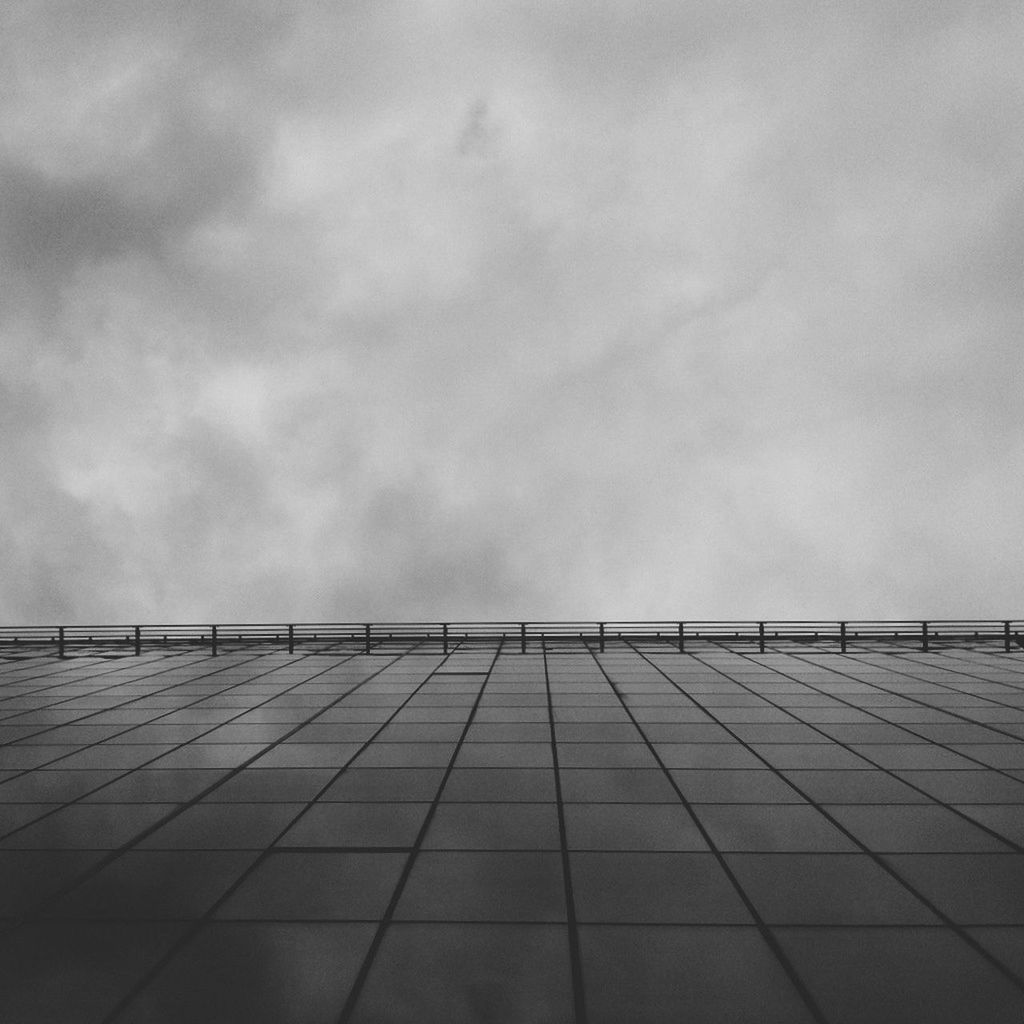 sky, built structure, architecture, building exterior, low angle view, cloud - sky, cloudy, day, outdoors, cloud, pattern, building, overcast, no people, city, modern, roof, architectural feature, in a row, high section