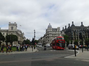 People on road in city against sky