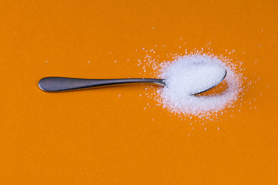 Directly above shot of ice cream against orange background