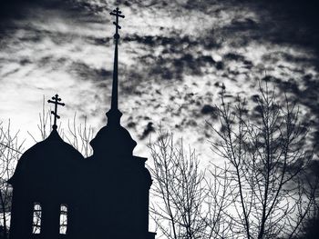 Low angle view of silhouette church against sky