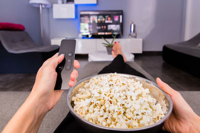 Midsection of man photographing food at home
