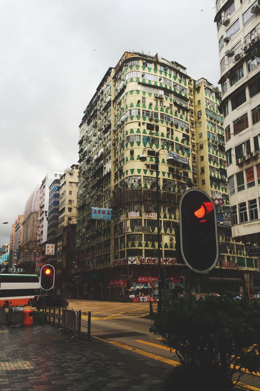 building exterior, architecture, built structure, city, transportation, sky, building, land vehicle, city life, mode of transport, car, street, office building, modern, low angle view, tower, skyscraper, city street, outdoors, street light