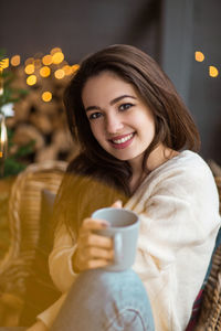 Portrait of a smiling young woman sitting outdoors