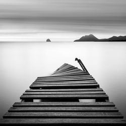 Pier on sea against sky