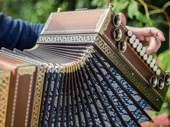 Cropped image of person playing accordion