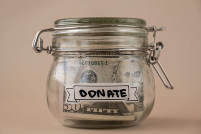 Close-up of coins in jar on table