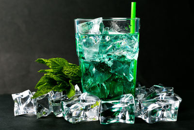 Close-up of wine glass on table against black background