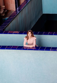 Woman sitting on staircase