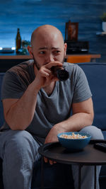 Mid adult man eating food