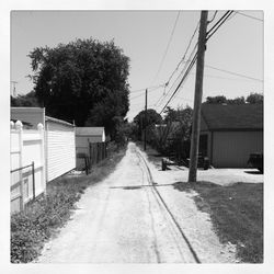 Empty road along buildings