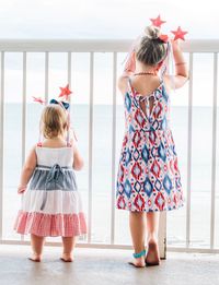 Full length of woman standing against wall