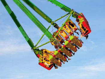 Low angle view of amusement park ride against sky