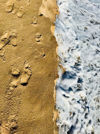 High angle view of sand and sea on beach