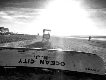 Text on beach against sky