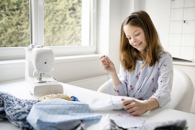 Mid adult woman sitting at home