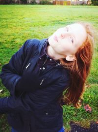 Portrait of smiling girl sitting on field