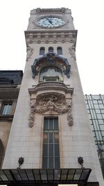 Low angle view of clock tower against clear sky