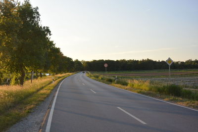 Empty road along countryside landscape