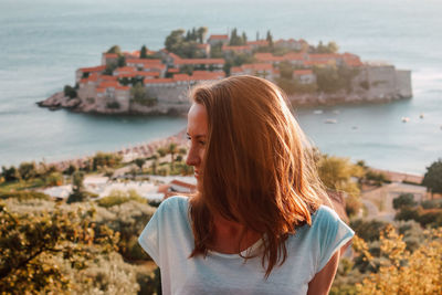 Midsection of woman on sea shore