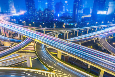 High angle view of light trails on highway at night