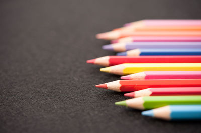 Close-up of multi colored pencils on table