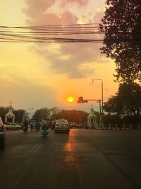 Road against cloudy sky at sunset