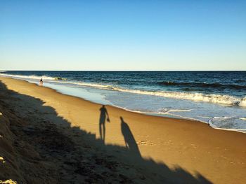 High angle view of shadows on beach against sky