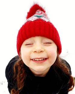 Close-up of smiling girl wearing knit hat