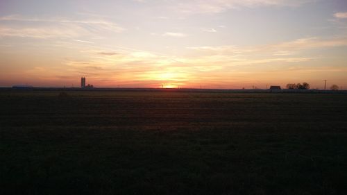 Scenic view of field against sky during sunset