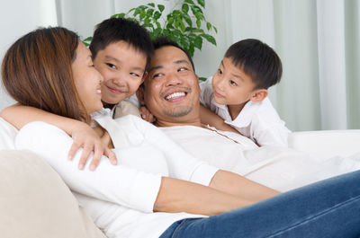 Happy family sitting on sofa at home