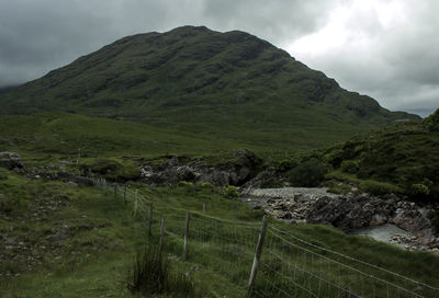 Scenic view of green mountains against sky