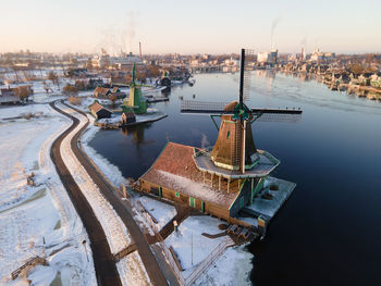 High angle view of pier on river in city against sky