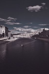 View of town against cloudy sky