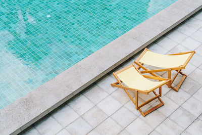 High angle view of chair in swimming pool