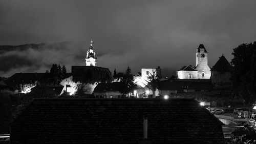 Illuminated building against sky at night