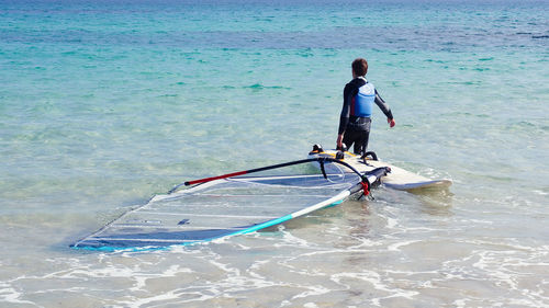 Rear view of man in sea