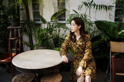 Woman looking away while sitting on seat