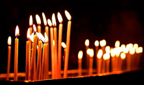 Close-up of burning candles in temple