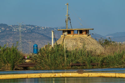 Built structure by sea against sky