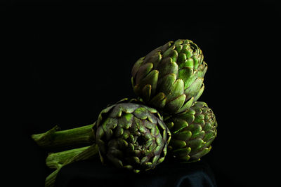 Close-up of green pepper against black background